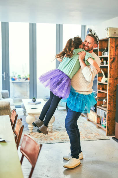 istock Shot of a father and daughter embracing while practicing a dance routine together at home 1358256631
