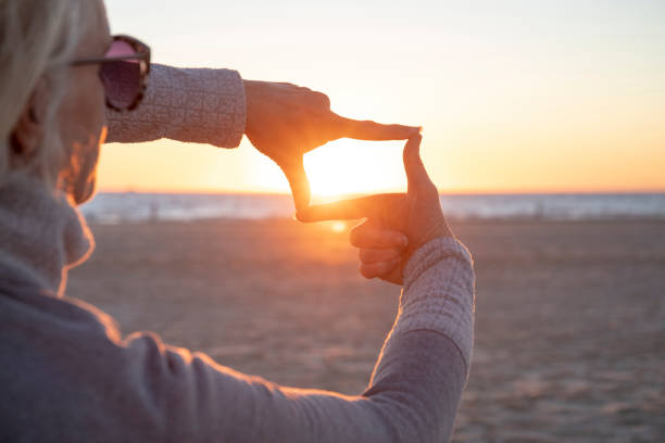 istock Woman relaxes on sandy beach at sunrise 1358257164