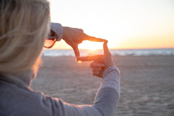 istock Woman relaxes on sandy beach at sunrise 1358257991
