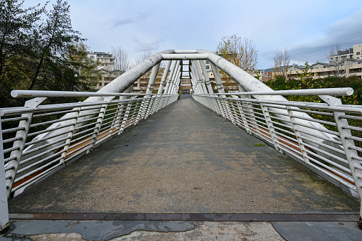 A wooden footbridge across a brook in the park