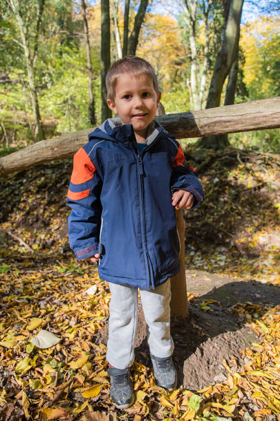 istock Child and nature. A beautiful boy in the forest. 1358261053