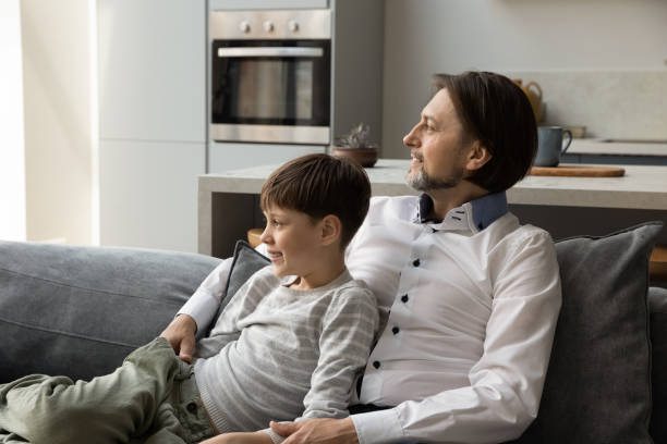 istock Happy dreamy multigenerational family resting on couch. 1358265926
