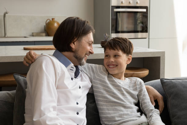 istock Happy father talking with teenage kid son. 1358265933