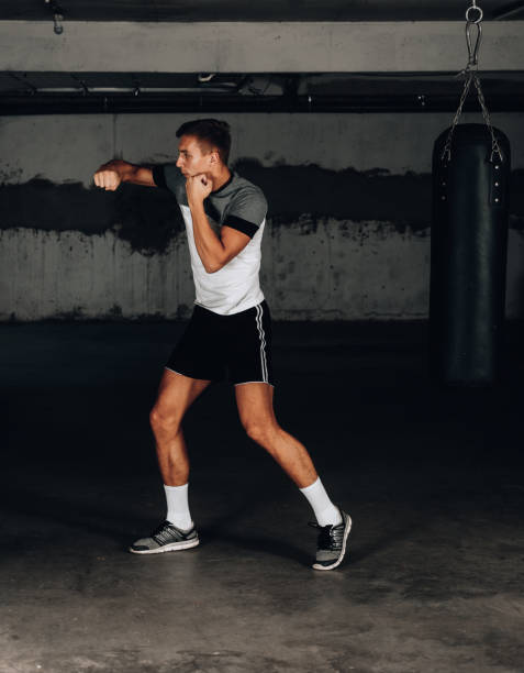 istock Young muscular sports guy practicing boxing 1358266732