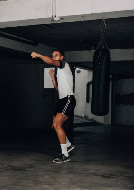 istock Young muscular sports guy practicing boxing 1358266741