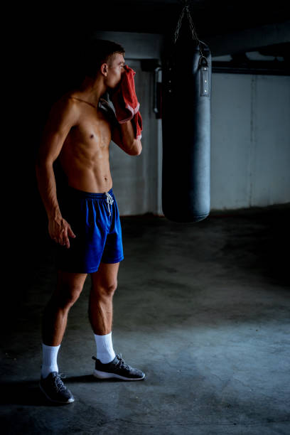 istock Fit man taking a break from working out at the gym 1358268293