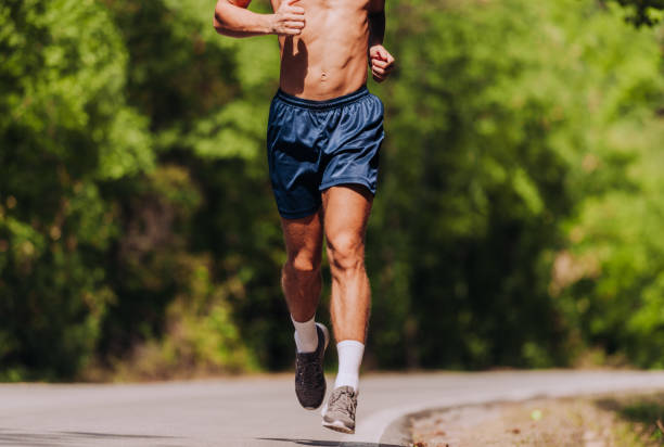 istock Sprinting runner man running at fast speed. Male sport sprinter training hard 1358268365