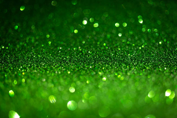 istock Dark green glitter lights. Shiny sparkles, bokeh effects, glowing surface. Selective focus, christmas abstract background 1358269401