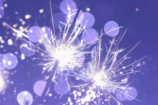 istock two classic sparklers with purple blurred bokeh lights on a black purple gradient background 1358269693