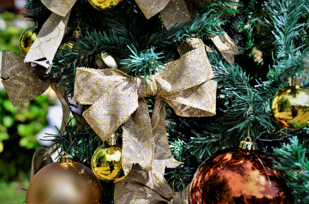 istock Jute lace with golden decorating Christmas tree 1358272075