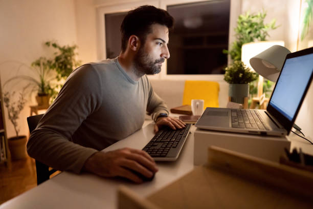istock Dedicated man trying to finish deadline while working late at night from home office 1358273455