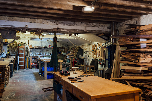Interior of a workshop/small business that works with sustainable locally sourced wood in the North East of England. There are multiple saws/other equipment/tools.
