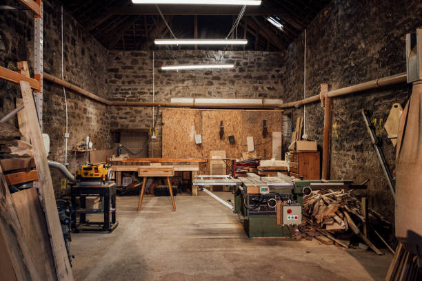 Small Wood Furniture Business Interior of a workshop/small business that works with sustainable locally sourced wood in the North East of England. There are multiple saws/other equipment/tools. woodshop stock pictures, royalty-free photos & images