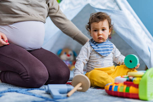 istock Baby boy playing at home whit his mother 1358277782