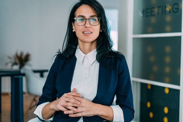 businesswoman talking during video call in the office. - business women manager looking at camera imagens e fotografias de stock