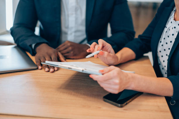 istock Business people signing a contract. 1358280400