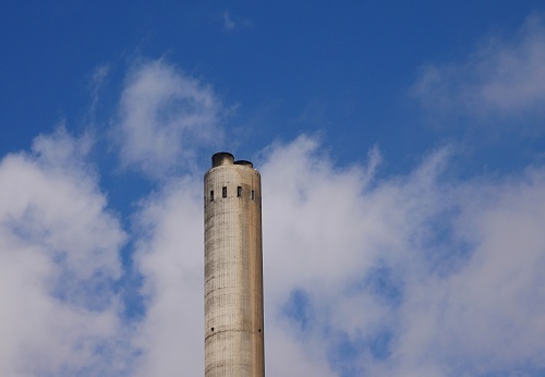 Chimney of power plant and sky with clouds in Santa Cruz de Tenerife, Canary Islands, Spain