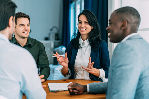 Group of business persons in business meeting. Multi-ethnic group of entrepreneurs on meeting in board room. Corporate business team on meeting in modern office.