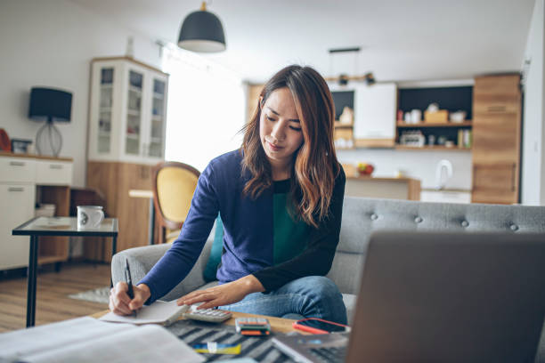 젊은 일본 여자 하 고 그녀의 재정 에 집에서 - tax tax form financial advisor finance 뉴스 사진 이미지