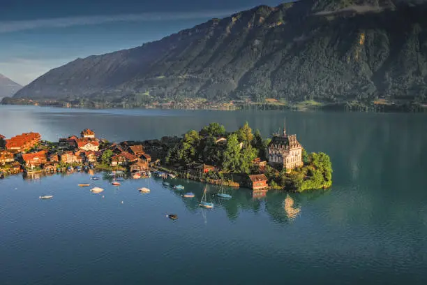 typical swiss village on blue lake at sunrise in Iseltwald, Canton of Bern, Switzerland