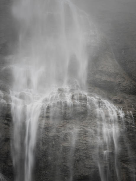 big waterfall over rocks in switzerland - jungfrau waterfall tree nature imagens e fotografias de stock