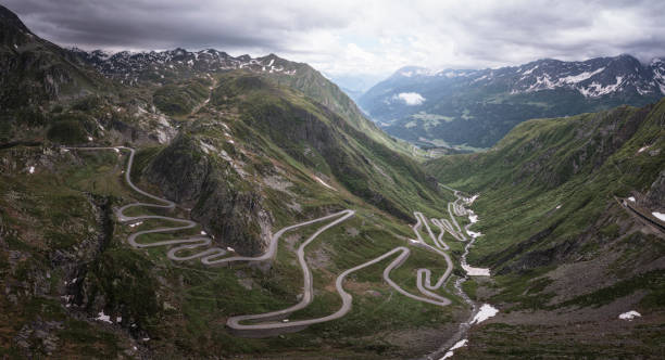 extreme curves in high mountains extreme curves in high mountains in Andermatt, Uri, Switzerland gotthard pass stock pictures, royalty-free photos & images