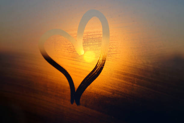 istock Heart painted on rainy window at sunset 1358281687