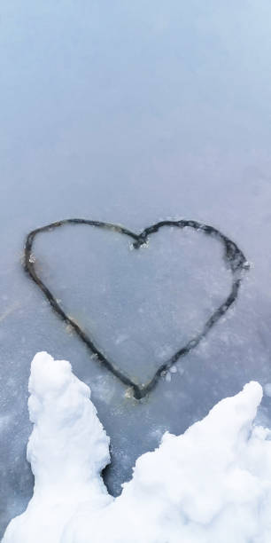 istock Heart-shaped drawing on an ice-covered lake in winter 1358281784