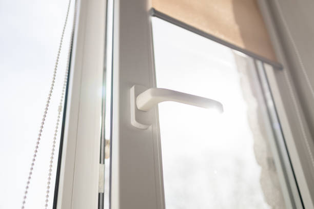 istock White plastic pvc window with forest background at home. Sunbeam through glass. Roll Blinds on the windows, the sun does not penetrate the house 1358281981