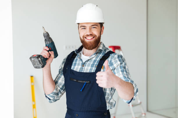 istock Portrait of bearded man builder with drill and thumb up 1358282341