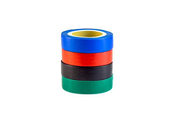 istock Red, green and blue adhesive insulating electrical tape reels stack isolated on white background 1358283110
