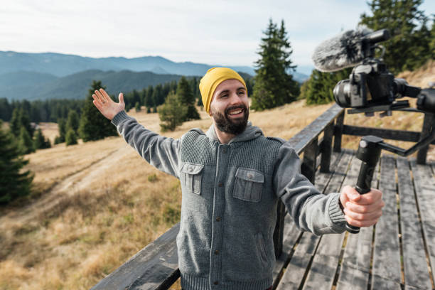 istock Young vlogger making a video in the mountains 1358283147
