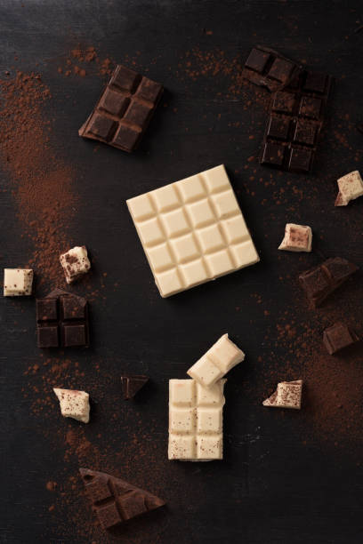istock Top view of white and dark crashed chocolate bar tiles 1358283516