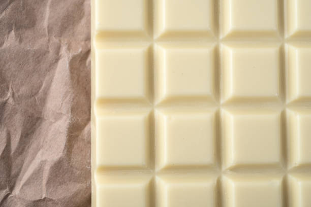 istock Close-up of white chocolate bar over paper 1358283740