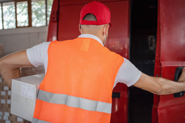 istock Male warehouse worker loading van with boxes full of goods 1358286059
