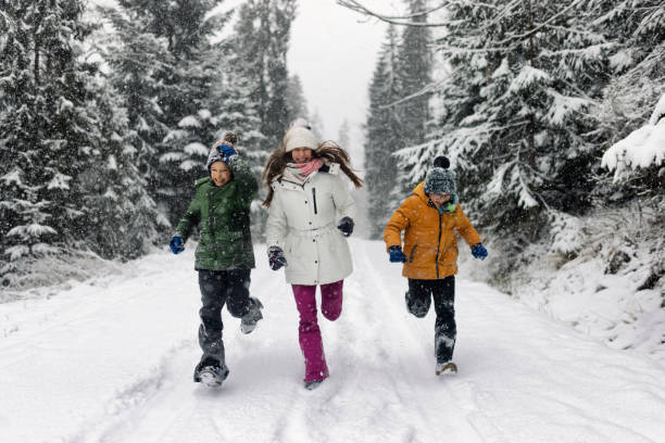 istock Kids running in beautiful forest in winter 1358287983