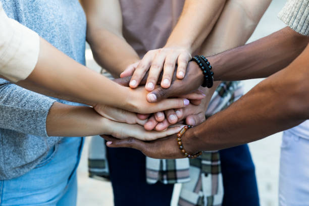 istock Group of friends stacking their hands 1358288140