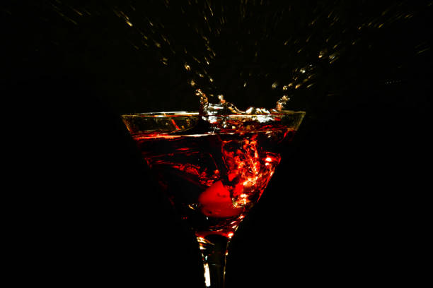 istock Close up of red martini cocktail splashing 1358289843