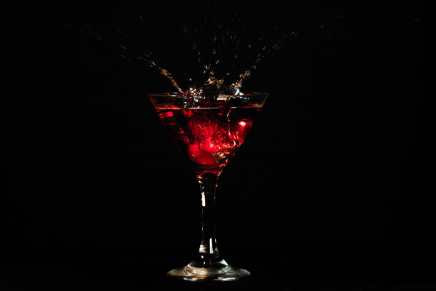 istock red martini cocktail splashing on black background 1358289849