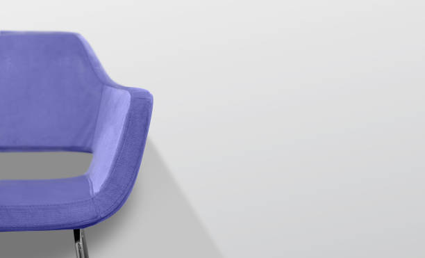 istock Yellow chair in front of a gray wall. Selective focus. 1358290981