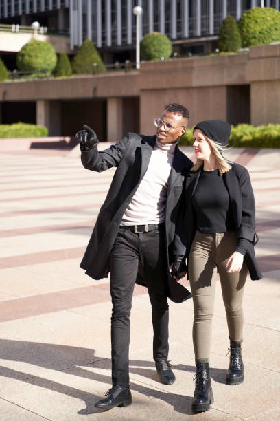 istock Black man showing street to girlfriend 1358292180