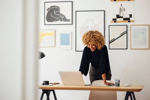 istock Smiling Afro-American Woman Standing in an Office 1358294032