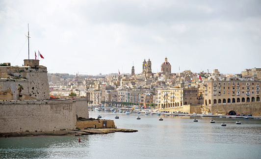 Ancient Valletta harbour panorama, Island of Malta, Mediterranean Sea. Malta is a central Mediterranean archipelago between Sicily and the North African coast,  known for its mellow sandstone architecture and historic sites reflecting the styles of rulers that include the Romans, Moors, Knights of Saint John, French and British