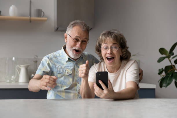 istock Excited happy elder couple getting message with good surprising news 1358295118