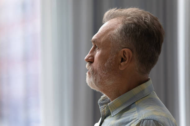 istock Sad thoughtful older 60s man looking out of window 1358295158