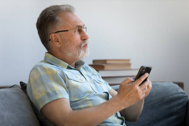 istock Thoughtful senior mobile phone user chatting online on smartphone 1358295194