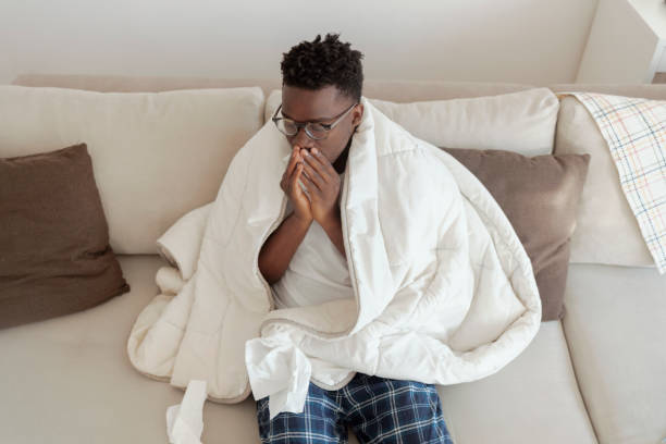 istock Sick man blowing his nose 1358295558