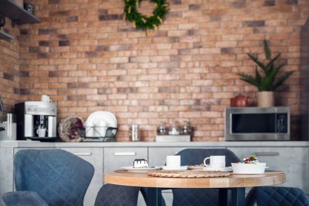 istock Spring kitchen table with serving napkin against background of Scandinavian room decor. Selective focus, interior, furniture. 1358299831