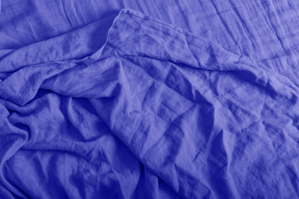 istock Crumpled linen texture in trendy blue 2022 color. Background for your text.. 1358299832