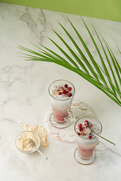 istock Dessert with chia seed pudding,jelly  a glass jar on a white background with a tropical palm tree 1358300747